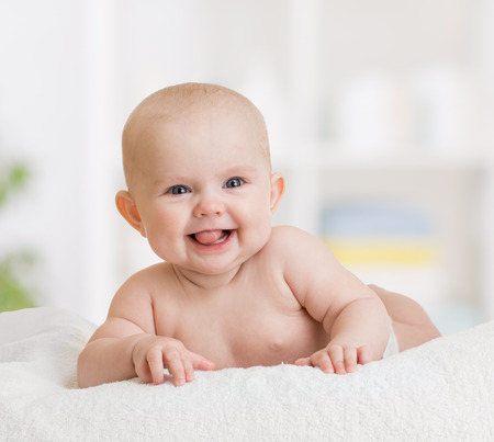 40505492 - smiling baby boy lying on towel