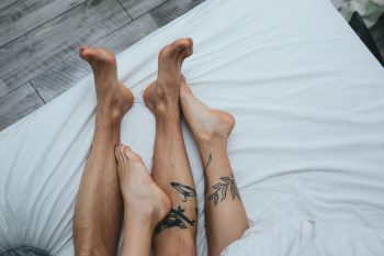 48424770 - young adult heterosexual couple lying on bed in bedroom